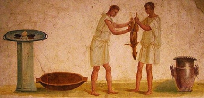 Seinämaalaus roomalaisista orjista valmistamassa ateriaa. Getty Villa, Malibu.